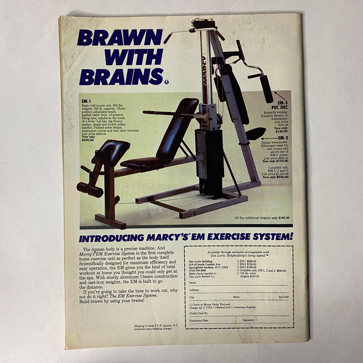 Back cover of Muscle Training Illustrated December 1986 showcasing an advertisement for Marcy's EM Exercise System. The design emphasizes the benefits of the equipment with detailed descriptions and pricing information.