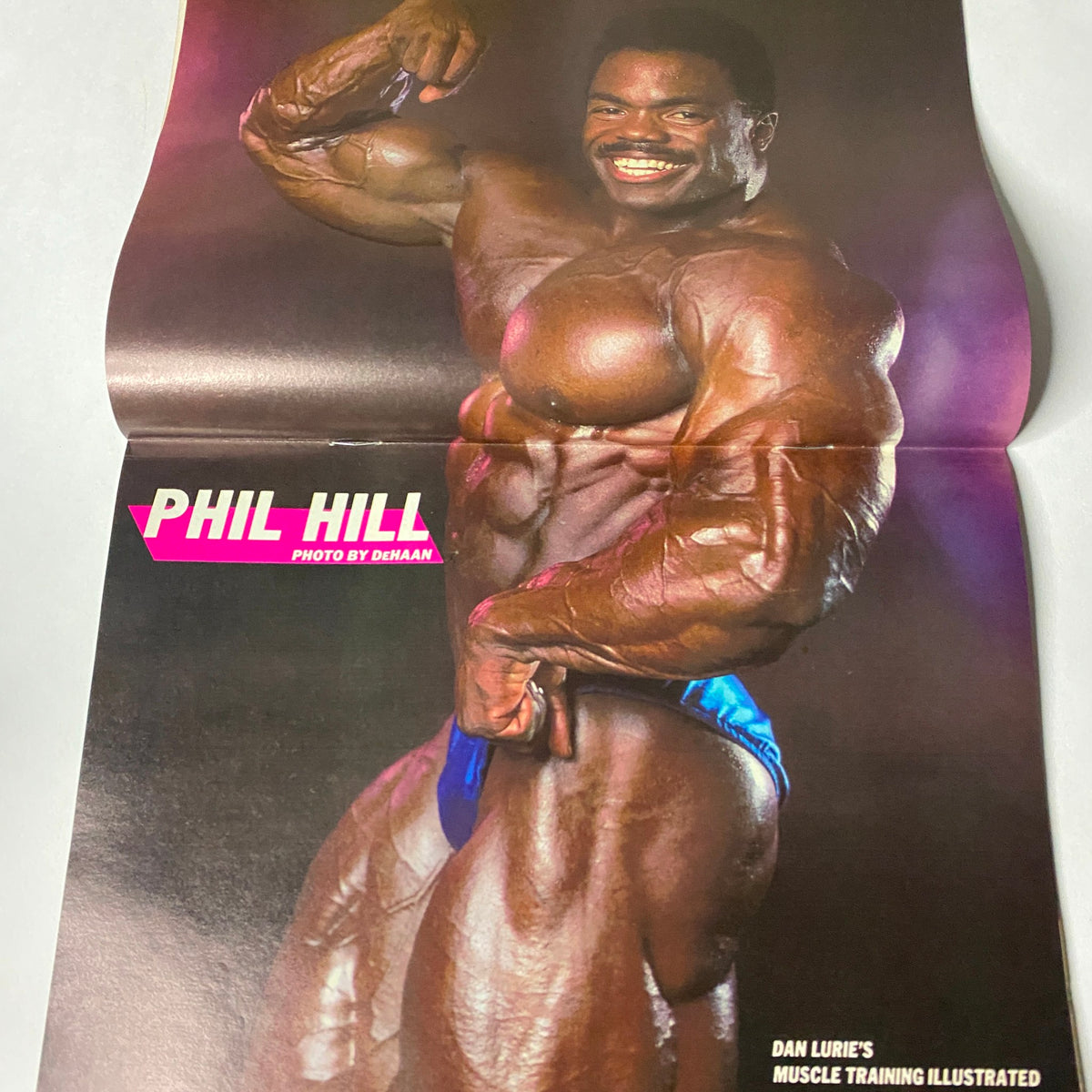 Centerfold from Muscle Training Illustrated July 1988, featuring Phil Hill showcasing his impressive physique and bodybuilding prowess.