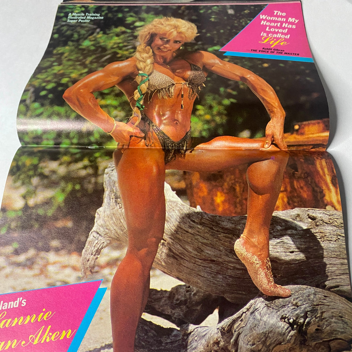 Centerfold from Muscle Training Illustrated April 1989 featuring Annie Aiken, a female bodybuilder posing in an outdoor setting, demonstrating strength and fitness.
