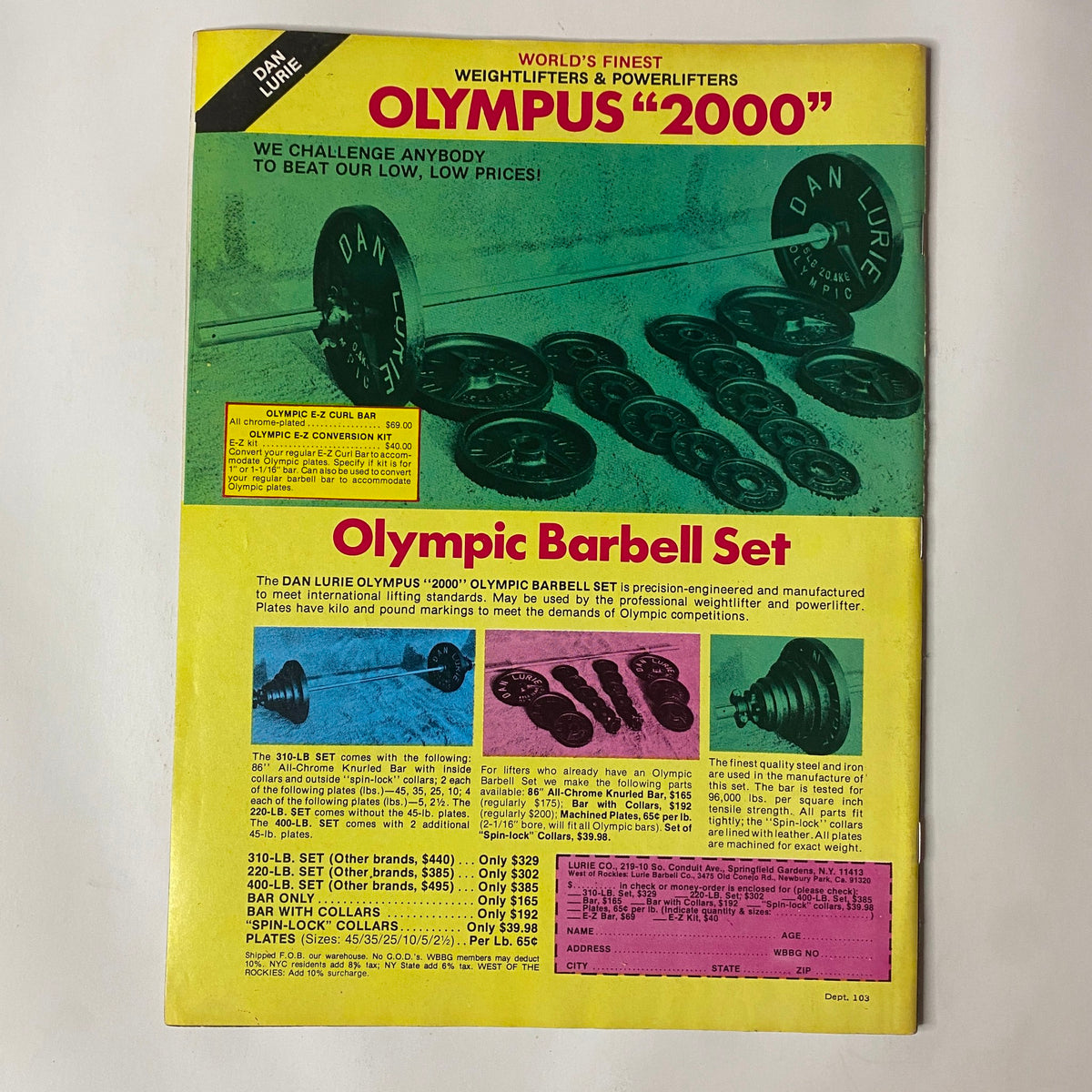 Advertisement for Dan Lurie's Olympus 2000 Olympic Barbell Set featured in Muscle Training Illustrated December 1982 No. 103 Steve Michalik. The image showcases the barbell set with weights and product details to challenge competitors on pricing.