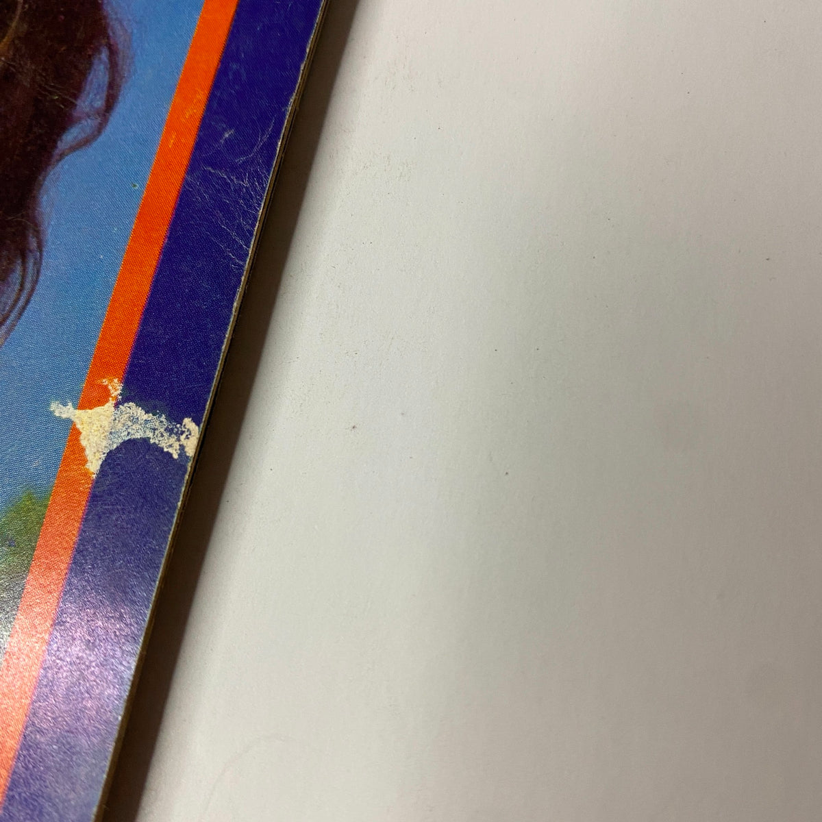 Close-up image showing the edge of the cover of Muscle Training Illustrated April 1981 with visible wear and tear, emphasizing the magazine's vintage nature.