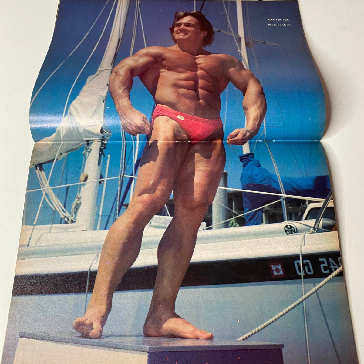 Centerfold of Muscle Training Illustrated January 1982, Issue No. 96 featuring a muscular bodybuilder posing in swimwear on a boat, highlighting the bodybuilding culture of the era.