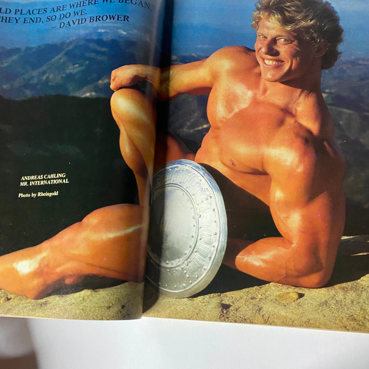 Centerfold image from Muscle Training Illustrated February 1982 No. 97 with Andreas Cauling, Mr. International, posed with a shield.
