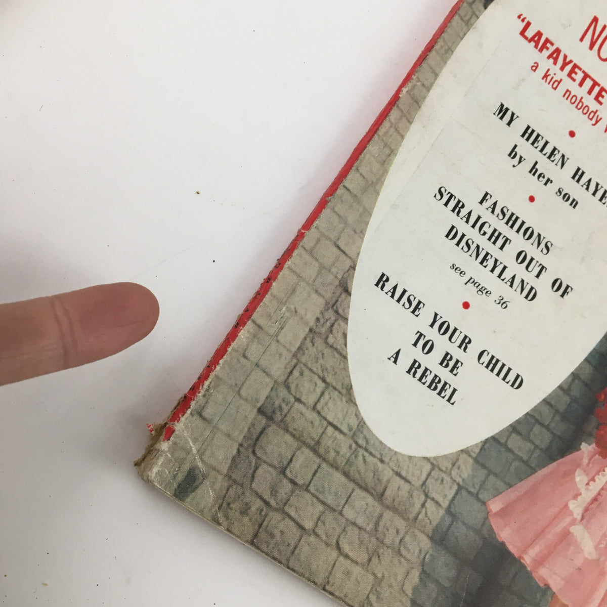 Close-up of the spine and side cover of McCall's Magazine February 1956, highlighting titles like 'Raise Your Child To Be A Rebel' and 'Fashions Straight Out of Disneyland.'