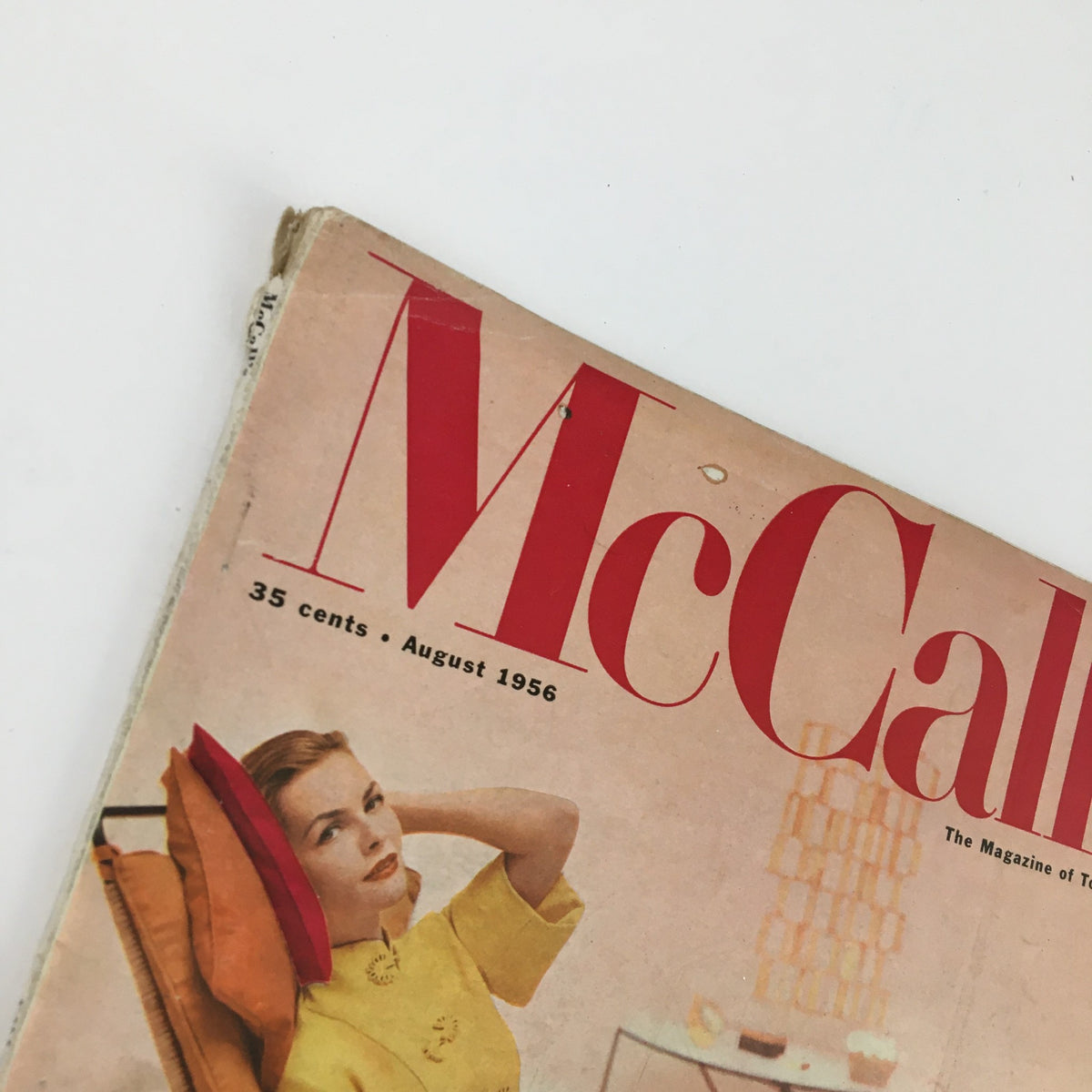 Close-up of the cover of McCall's Magazine August 1956 highlighting the magazine title, date, and a woman's portrait in a stylish outfit, emphasizing its vintage appeal.