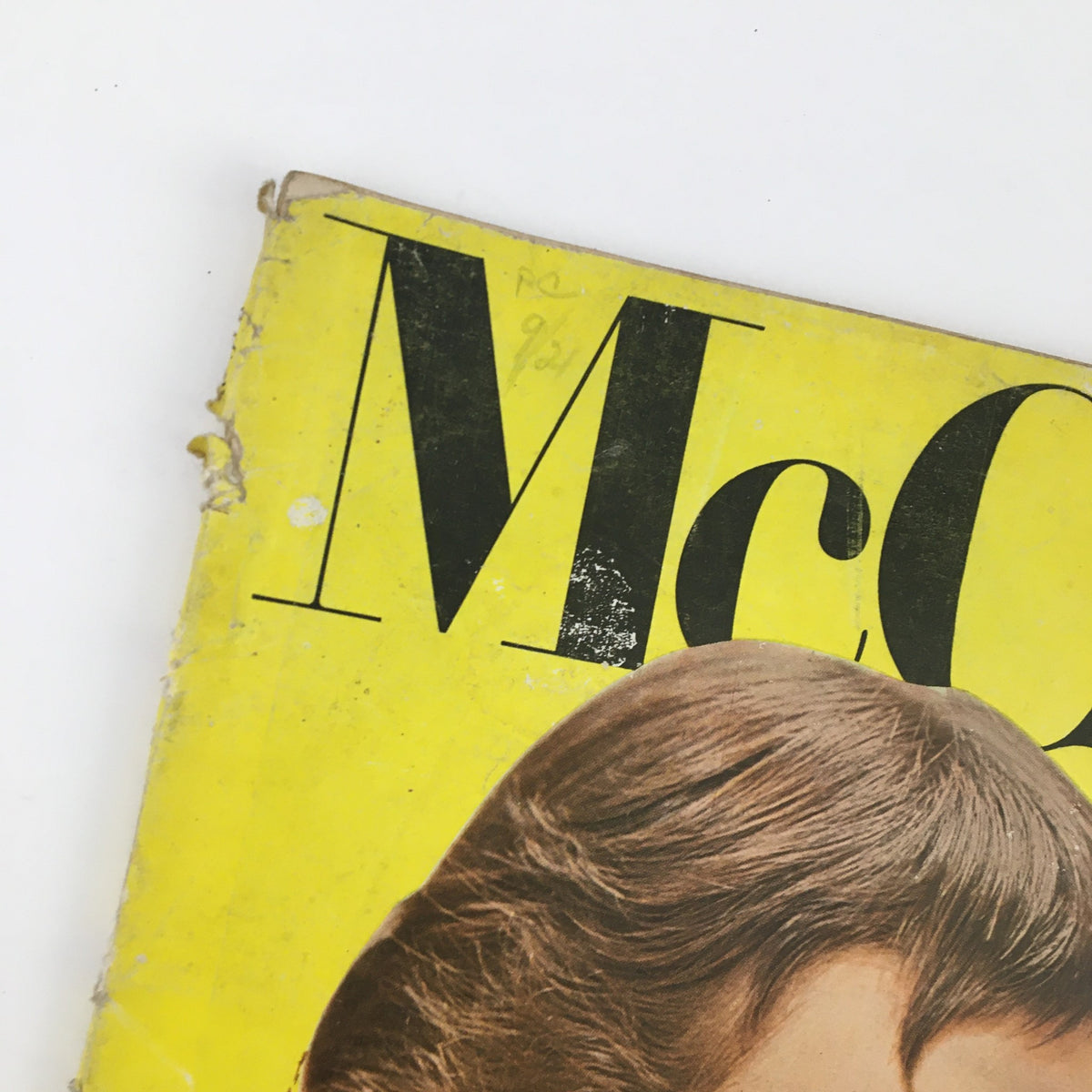 Detailed shot of the top of McCall's Magazine, October 1954, focusing on the magazine title and noticeable wear on the cover.