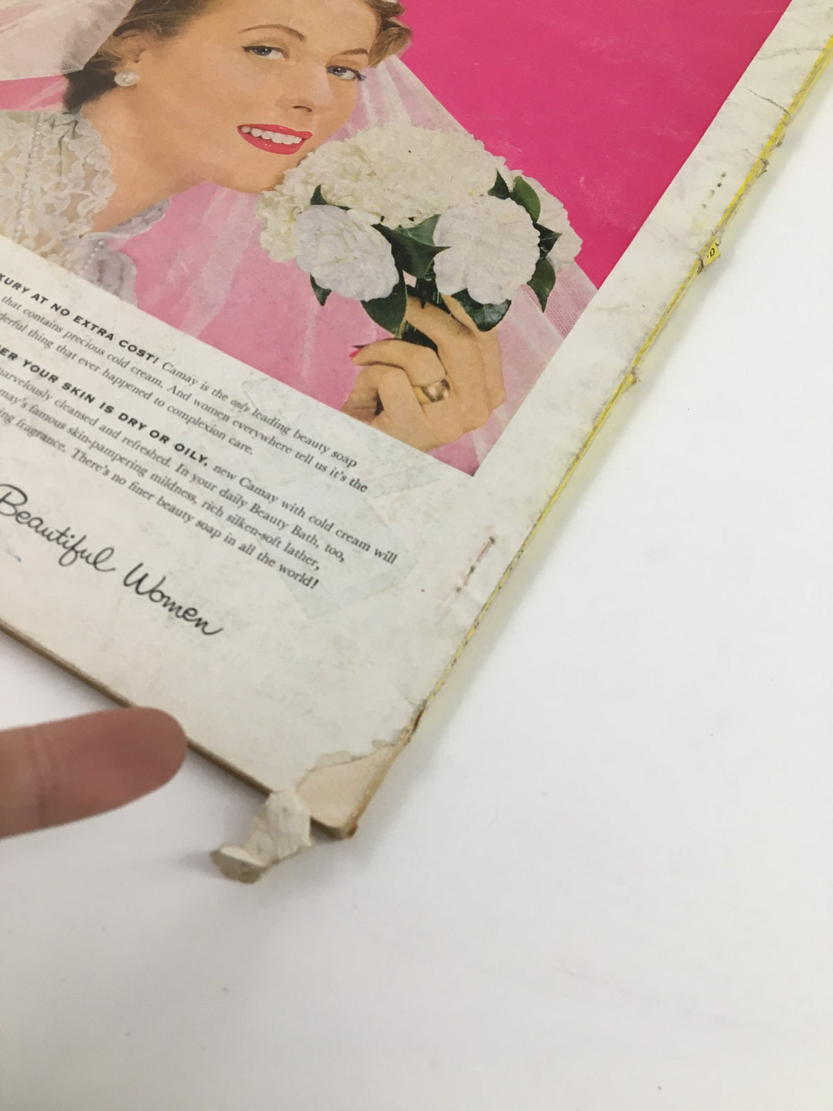 Vintage McCall's Magazine from October 1954 featuring a close-up of a woman with flowers, highlighting the era's beauty trends and culture.