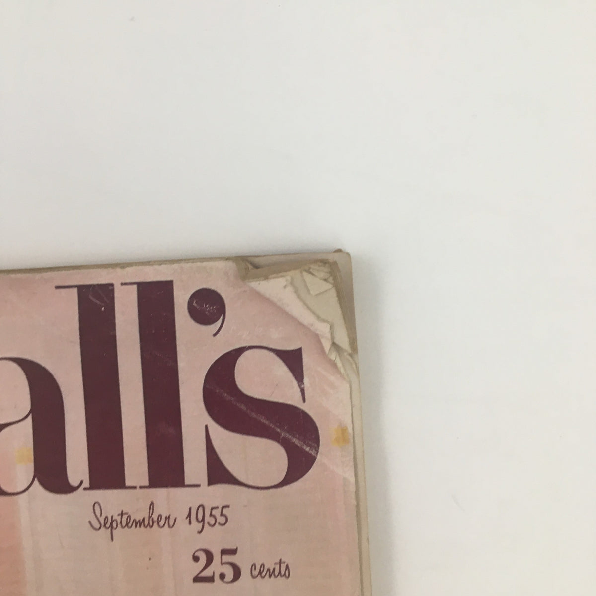 Close-up view of the top left corner of McCall's Magazine September 1955 showing the magazine title and date with visible aging and wear.