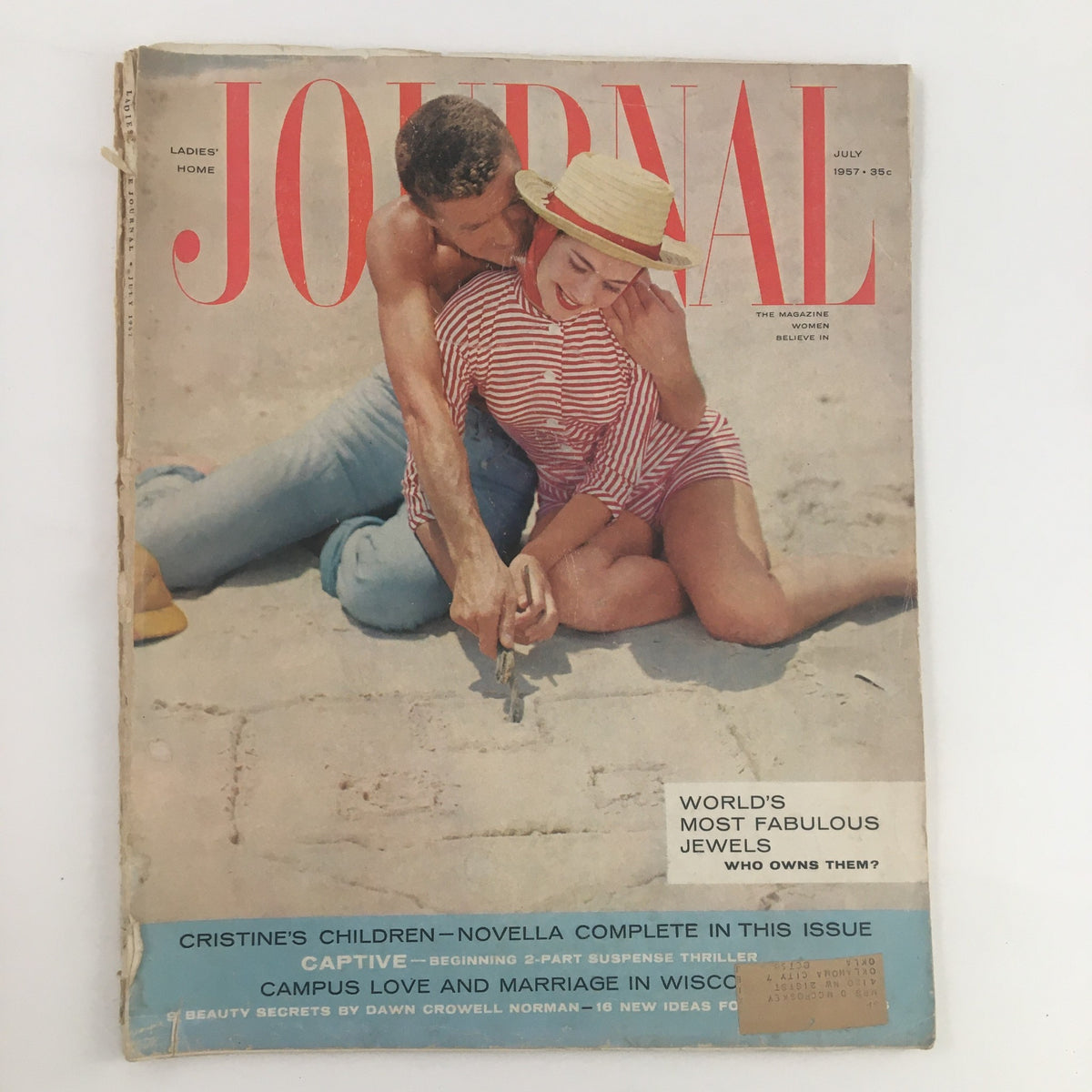 Ladies' Home Journal Magazine July 1957 cover featuring a couple at the beach, adorned with the title 'The World's Most Fabulous Jewels'.