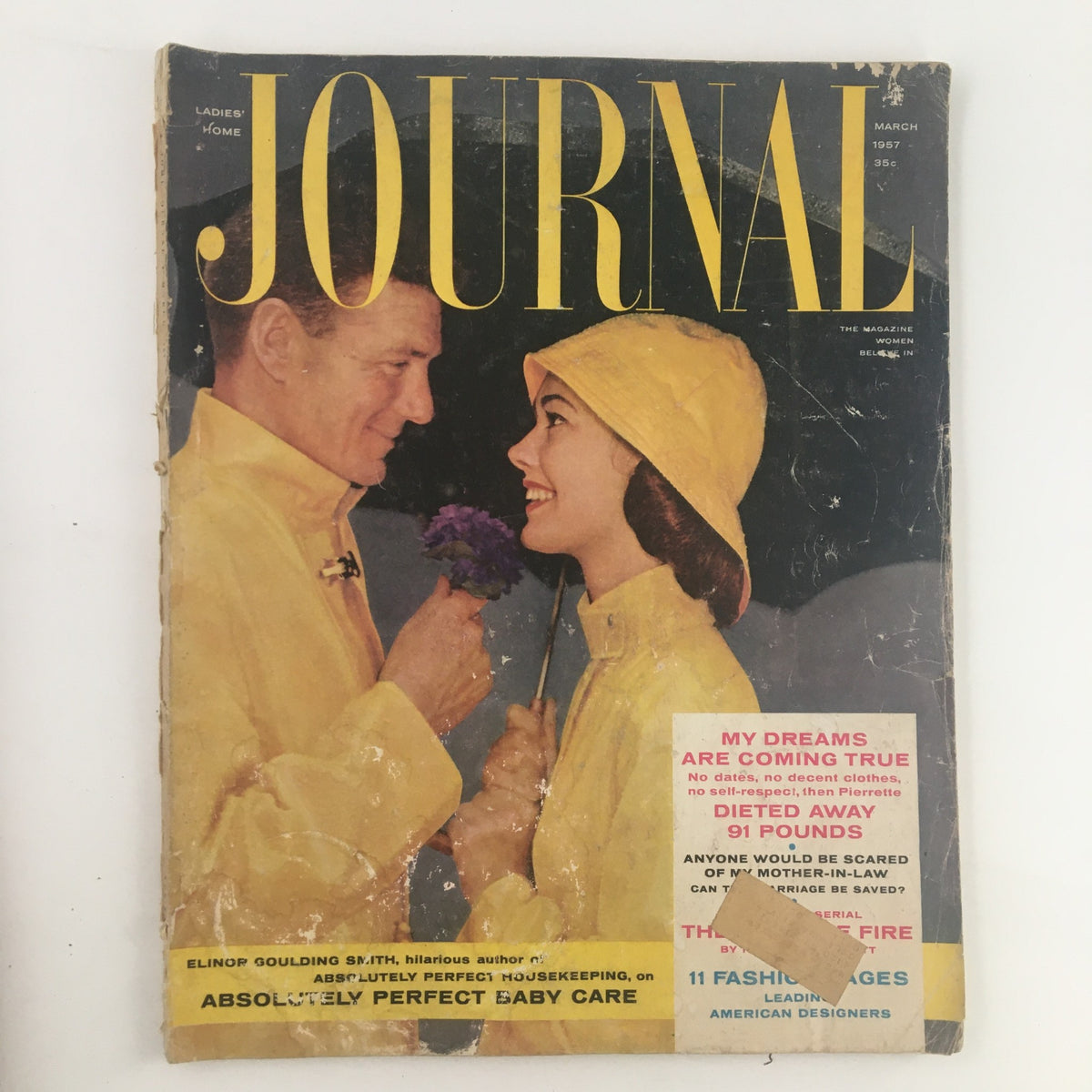 Cover of Ladies' Home Journal Magazine March 1957 featuring a couple in yellow raincoats, highlighting the theme 'Absolutely Perfect Baby Care'.