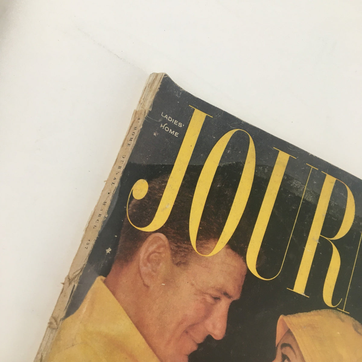 Top view of the cover of Ladies' Home Journal Magazine March 1957, showing the title and detail of a couple smiling.