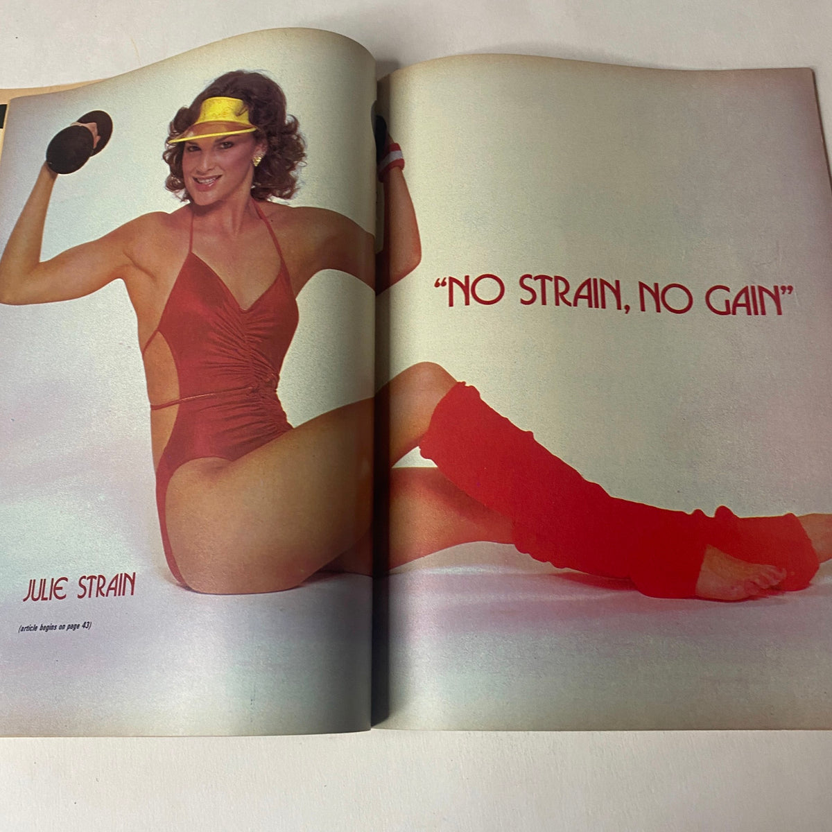 Muscle Up Magazine December 1982 featuring Julie Strain in a striking pose with the phrase 'NO STRAIN, NO GAIN' emphasizing fitness and bodybuilding aesthetic.