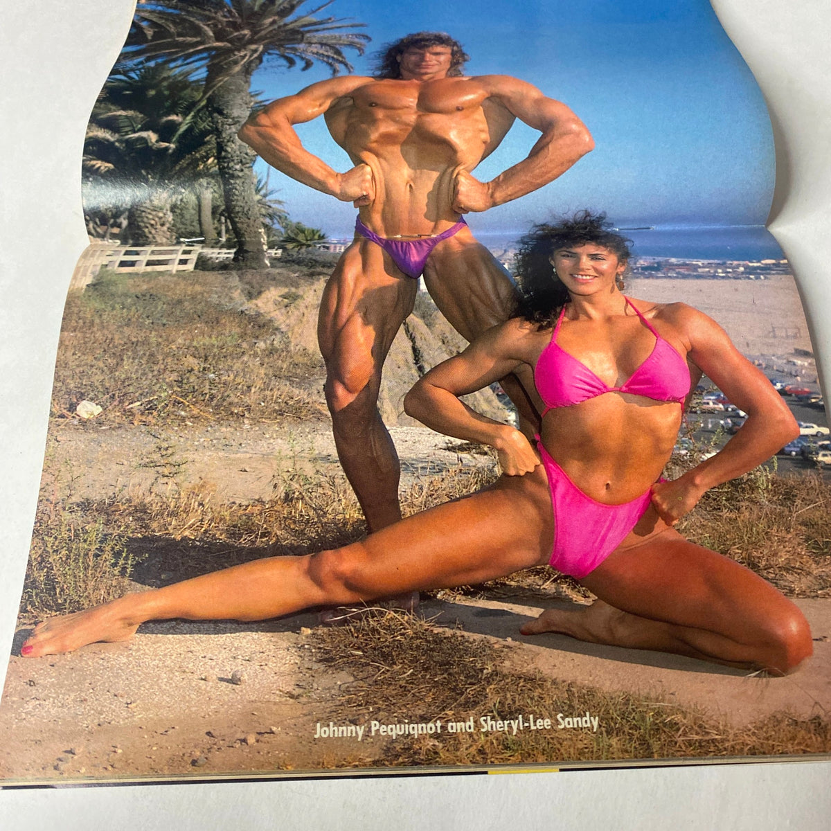 Centerfold of Natural Physique Magazine March 1990 featuring bodybuilders Johnny Pequinot and Sheryl-Lee Sandy posing to promote natural bodybuilding culture.