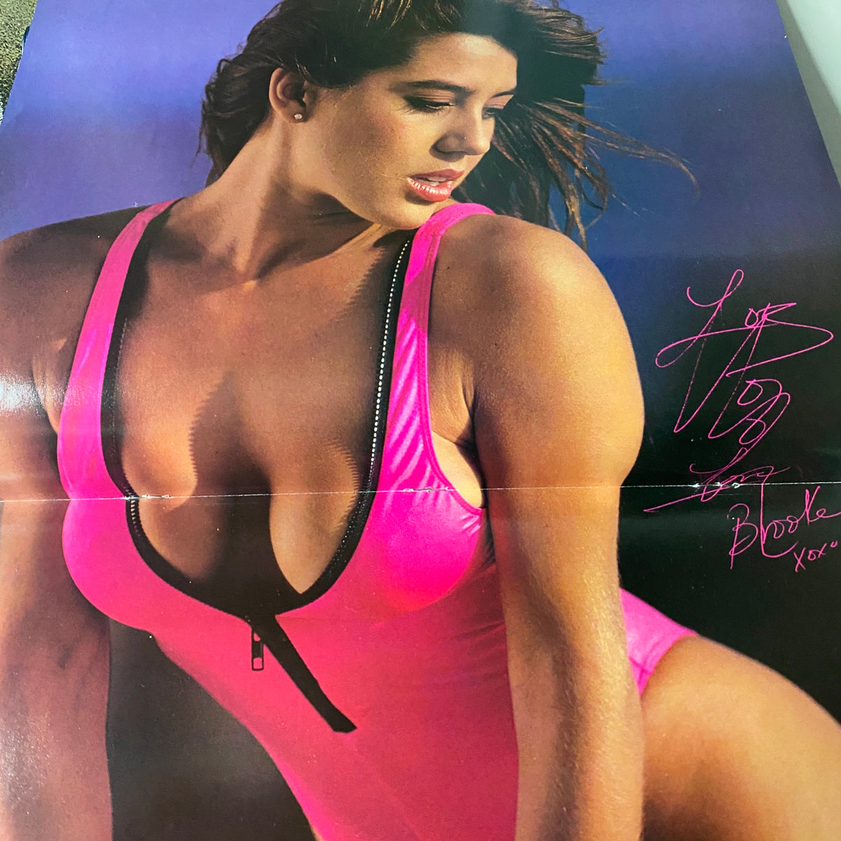 Vintage magazine poster featuring a model in a pink swimsuit, showcasing body positivity and fitness style, from the Super Fitness Excel Magazine September 1990 Vol 1 No. 1 Lee Labrada issue.