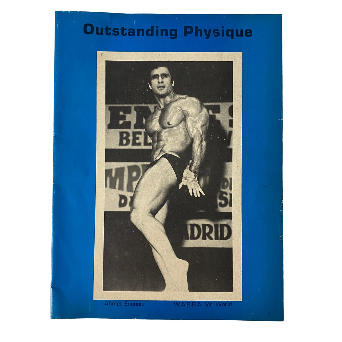 Cover of the 1975 Muscular Development featuring Outstanding Physique by Ahmet Enunulu, showcasing a male bodybuilder posed on stage.