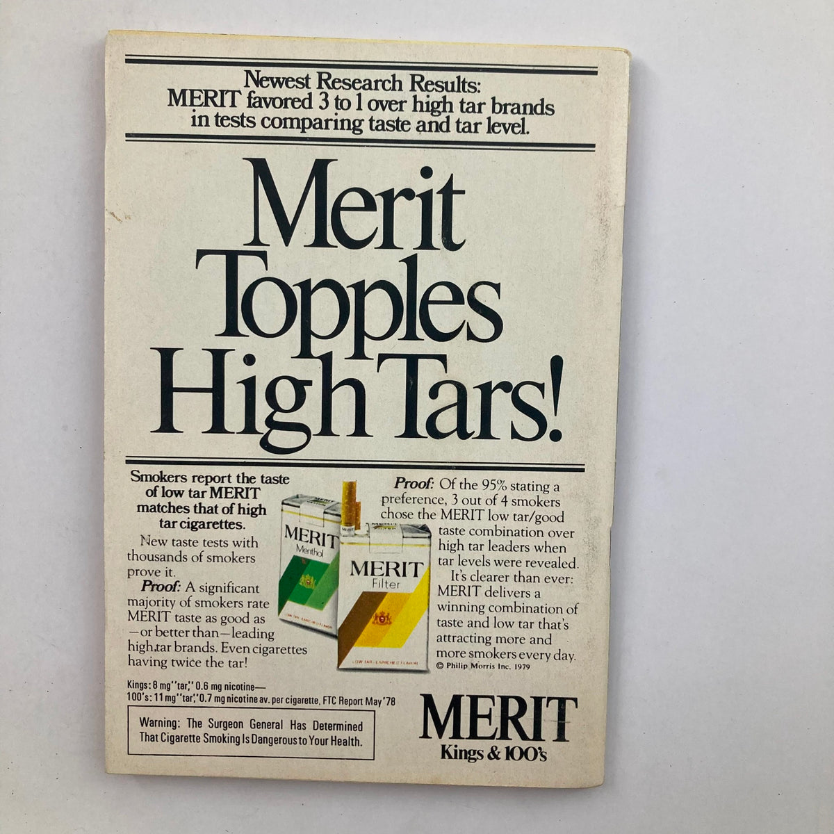 Merit advertisement featuring the slogan 'Merit Topples High Tars!' showcasing low tar Merit cigarette products in a vintage magazine format from 1979. The ad highlights taste preference research results comparing low tar and high tar brands.