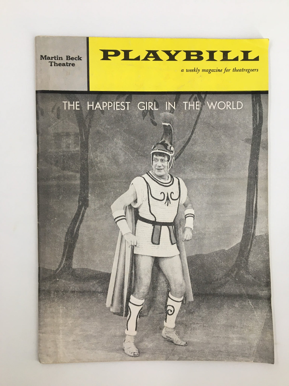 1961 Playbill titled The Happiest Girl in the World featuring a performer in traditional costume from the Martin Beck Theatre.