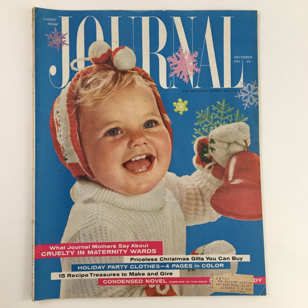 Cover of Ladies' Home Journal Magazine December 1958, titled 'The Cruelty in Maternity Wards', featuring a smiling baby wearing a festive outfit against a colorful blue background with holiday accents.