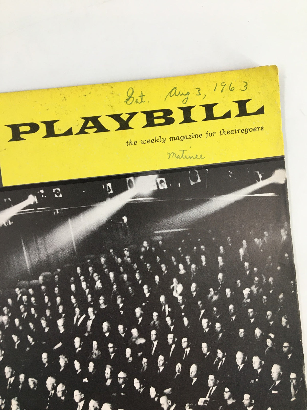 Cover of the 1963 Playbill for Stop The World - I Want To Get Off, featuring a historic photograph of an audience with a bright yellow header.