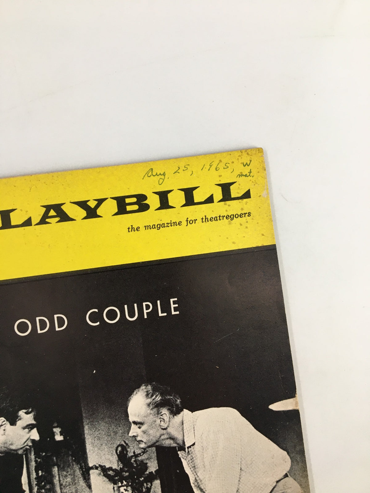 Close-up of the 1965 Playbill for The Odd Couple, with a focus on the title and a handwritten date, August 25, 1965, emphasizing its historical significance and connection to the Plymouth Theatre.