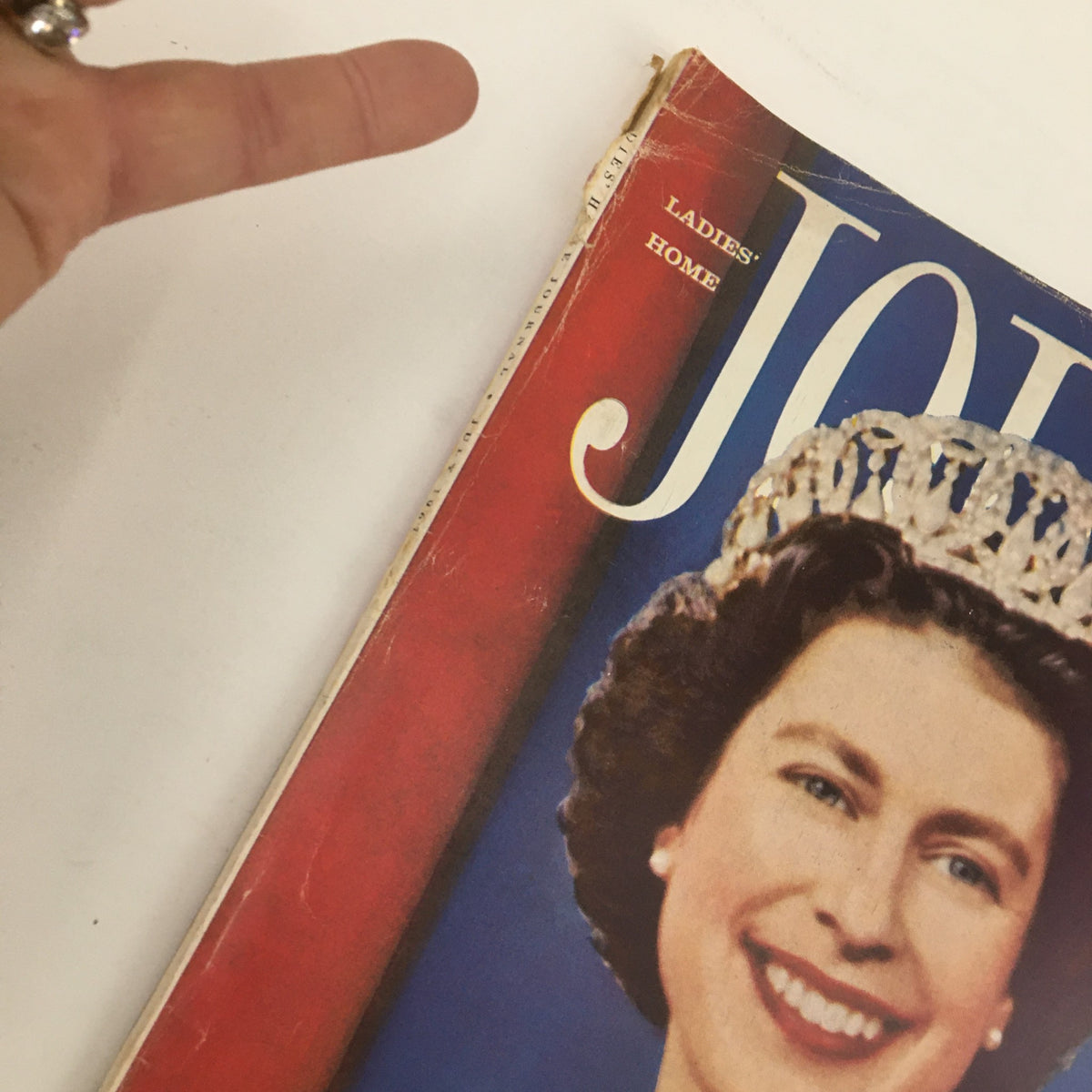 Close-up of the Ladies' Home Journal Magazine from July 1961, showcasing the cover with Queen Elizabeth II and an elegant royal look.