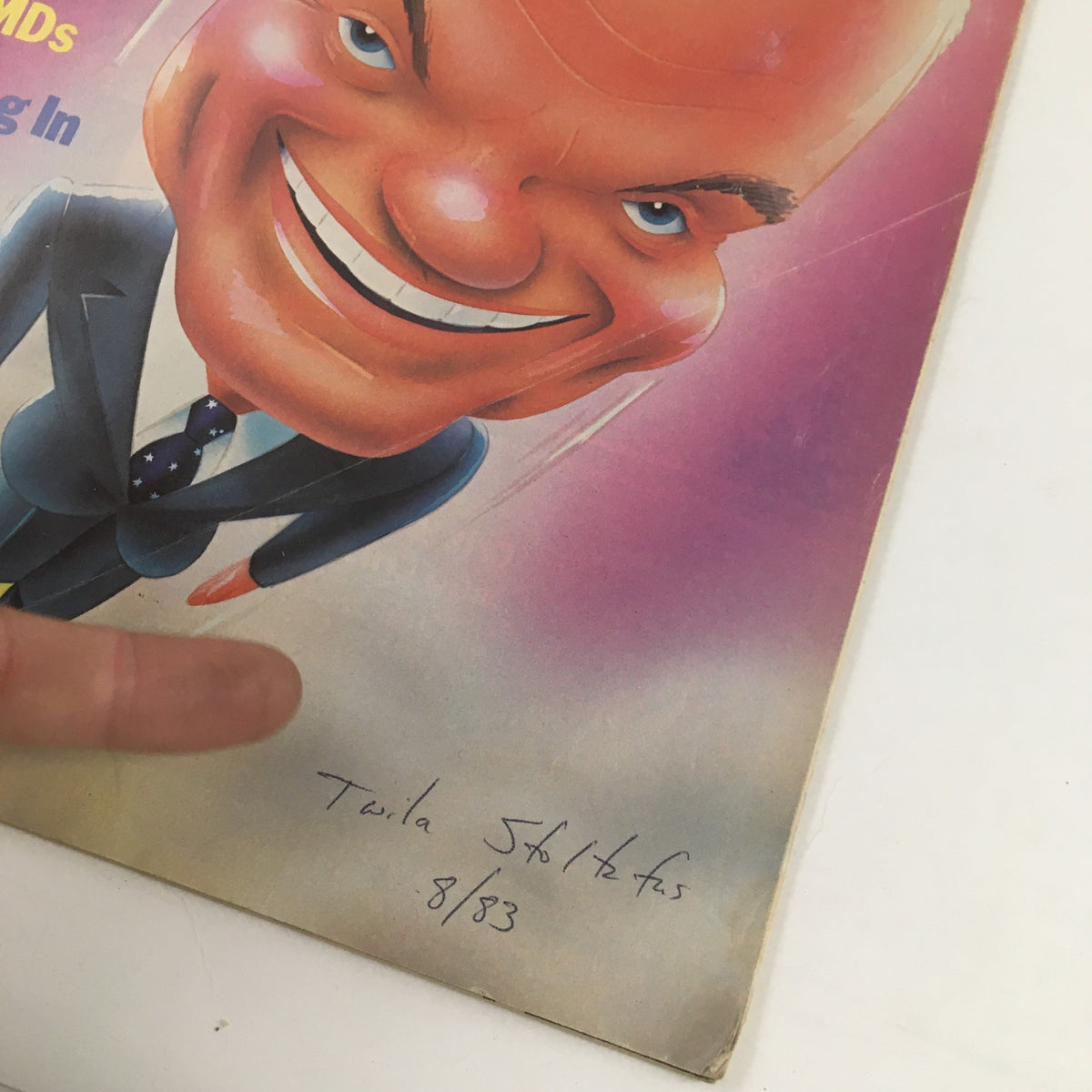 Close-up of the Mother Jones Magazine May 1983 cover showcasing the caricature of a smiling doctor alongside the handwritten signature 'Twila Stolefus 8/83'. This detail highlights the artwork's personal touch and the magazine's vintage appeal.