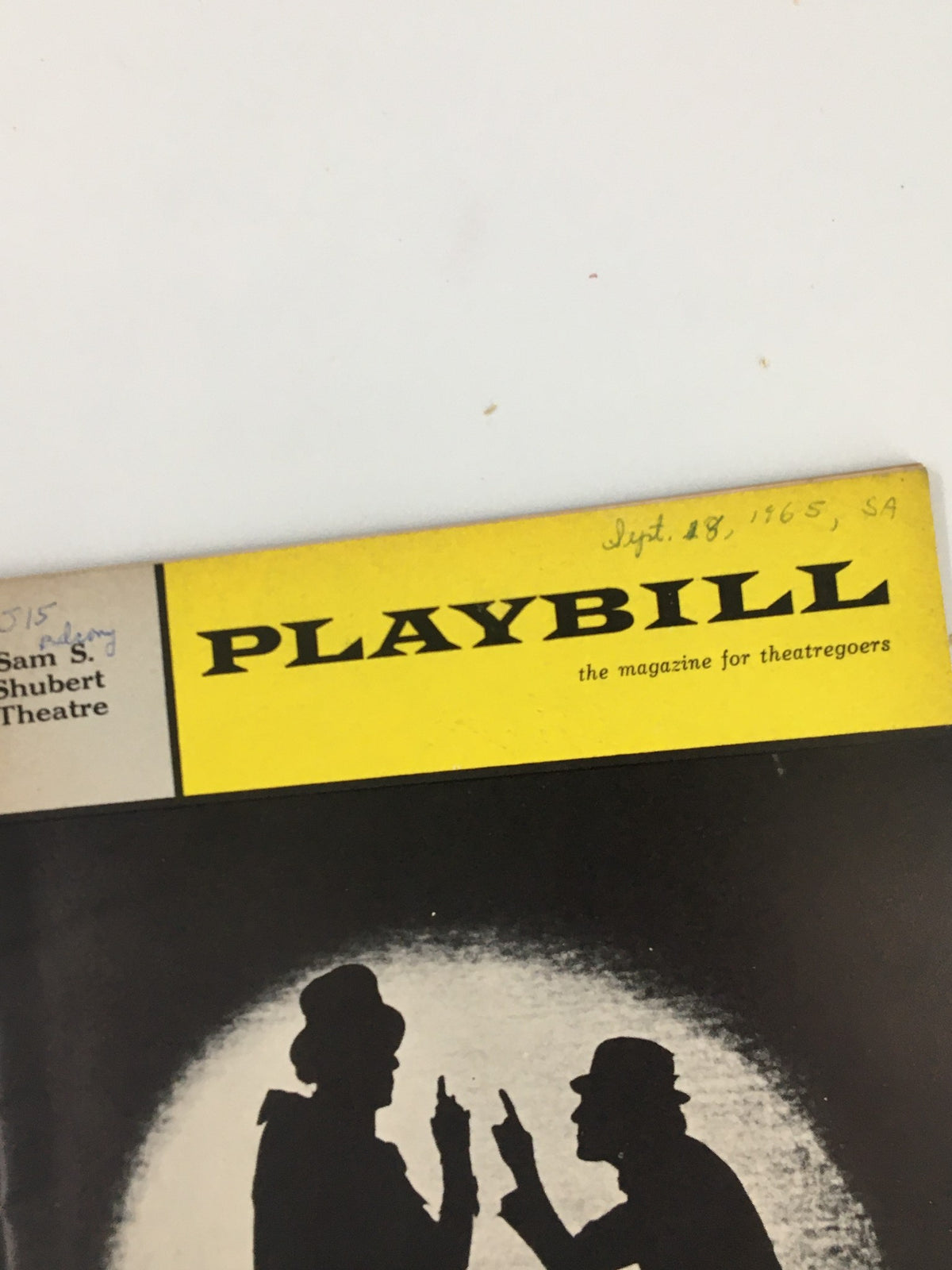 Close-up of the 1965 Playbill for 'The Roar of The Greasepaint - The Smell of the Crowd,' showcasing detailed title and vintage design from the Sam S. Shubert Theatre.