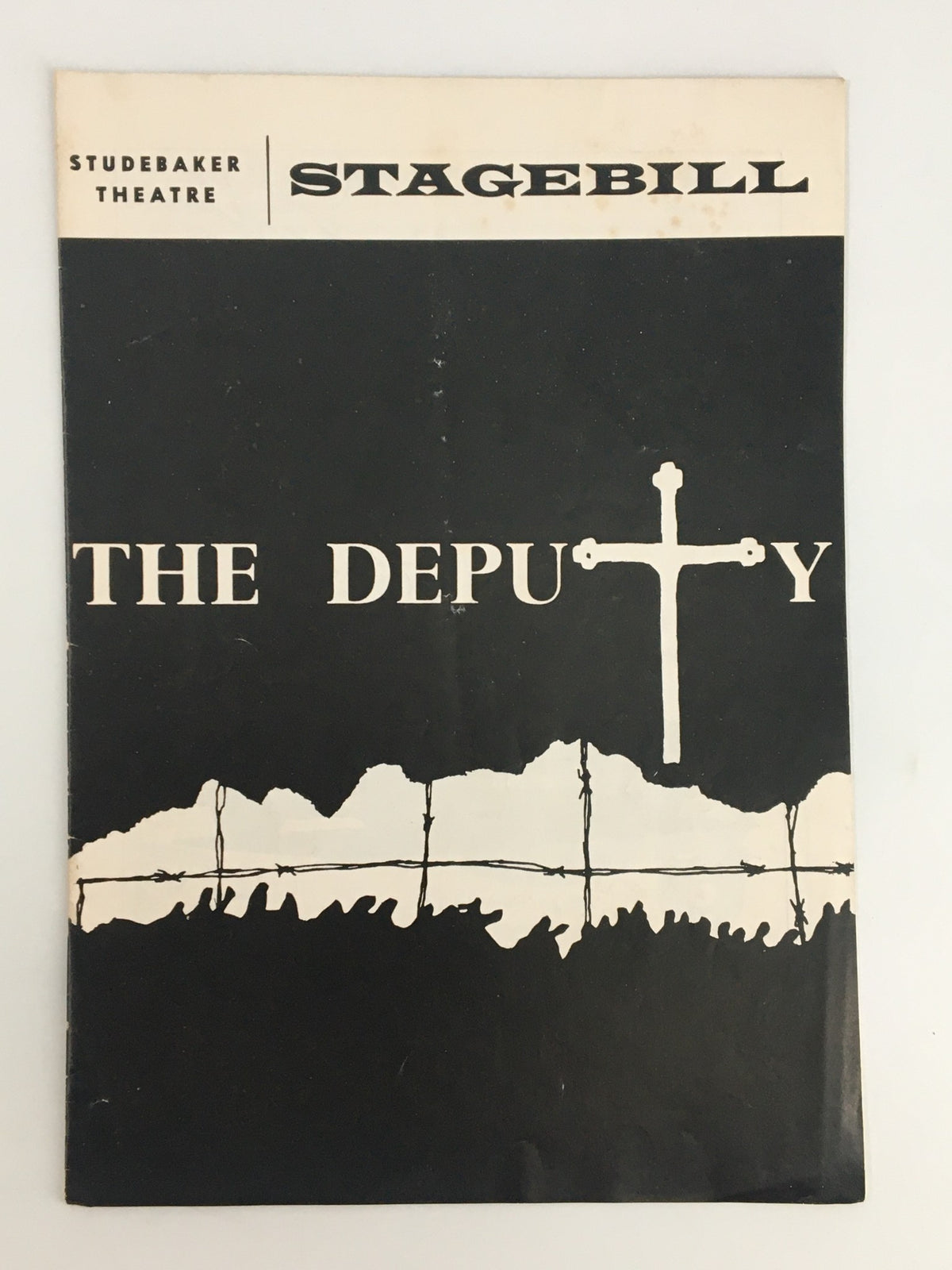 1966 Stagebill for 'The Deputy' by Rolf Hochhuth at the Studebaker Theatre, featuring a minimalist black cover with a white cross and barbed wire design.