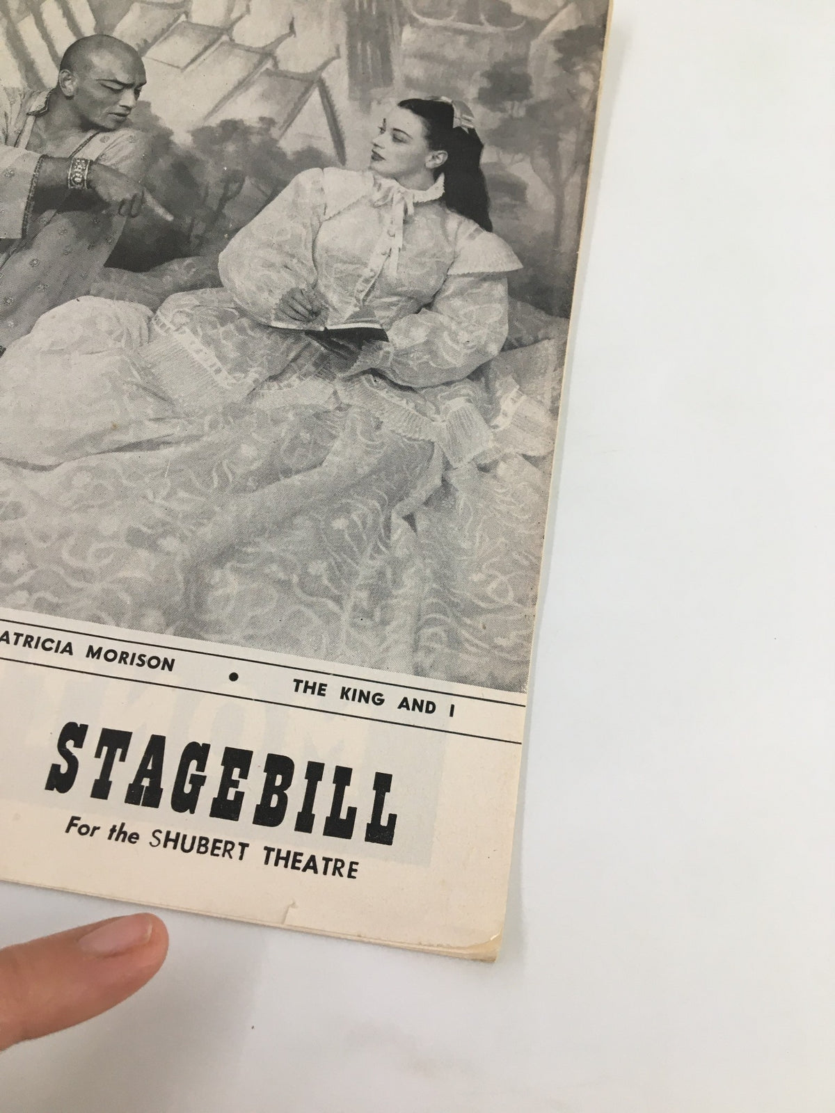 Close-up view of the 1954 Stagebill for the Shubert Theatre featuring Yul Brynner and Patricia Morison in The King and I, highlighting the title and actors.