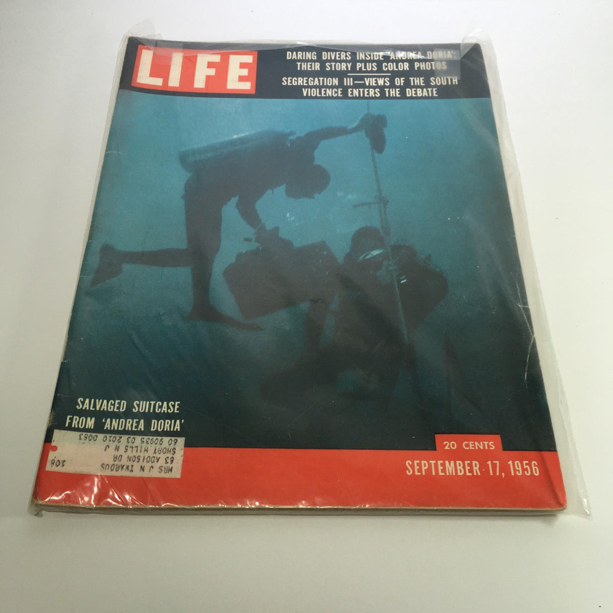 Cover of Life Magazine dated September 17, 1956, featuring the article 'Daring Divers Inside Andrea Doria: Their Story.' The cover displays divers exploring underwater, highlighting a salvaged suitcase. This vintage magazine showcases significant maritime history and exploration.