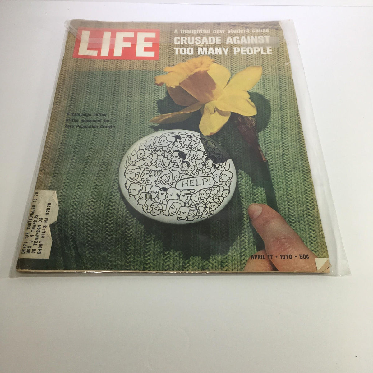Life Magazine dated April 17, 1970, featuring the cover story 'Crusade Against Too Many People'. The cover showcases a hand holding a circular pin with the word 'HELP!' surrounded by numerous illustrated faces, along with a yellow daffodil against a knitted green background.