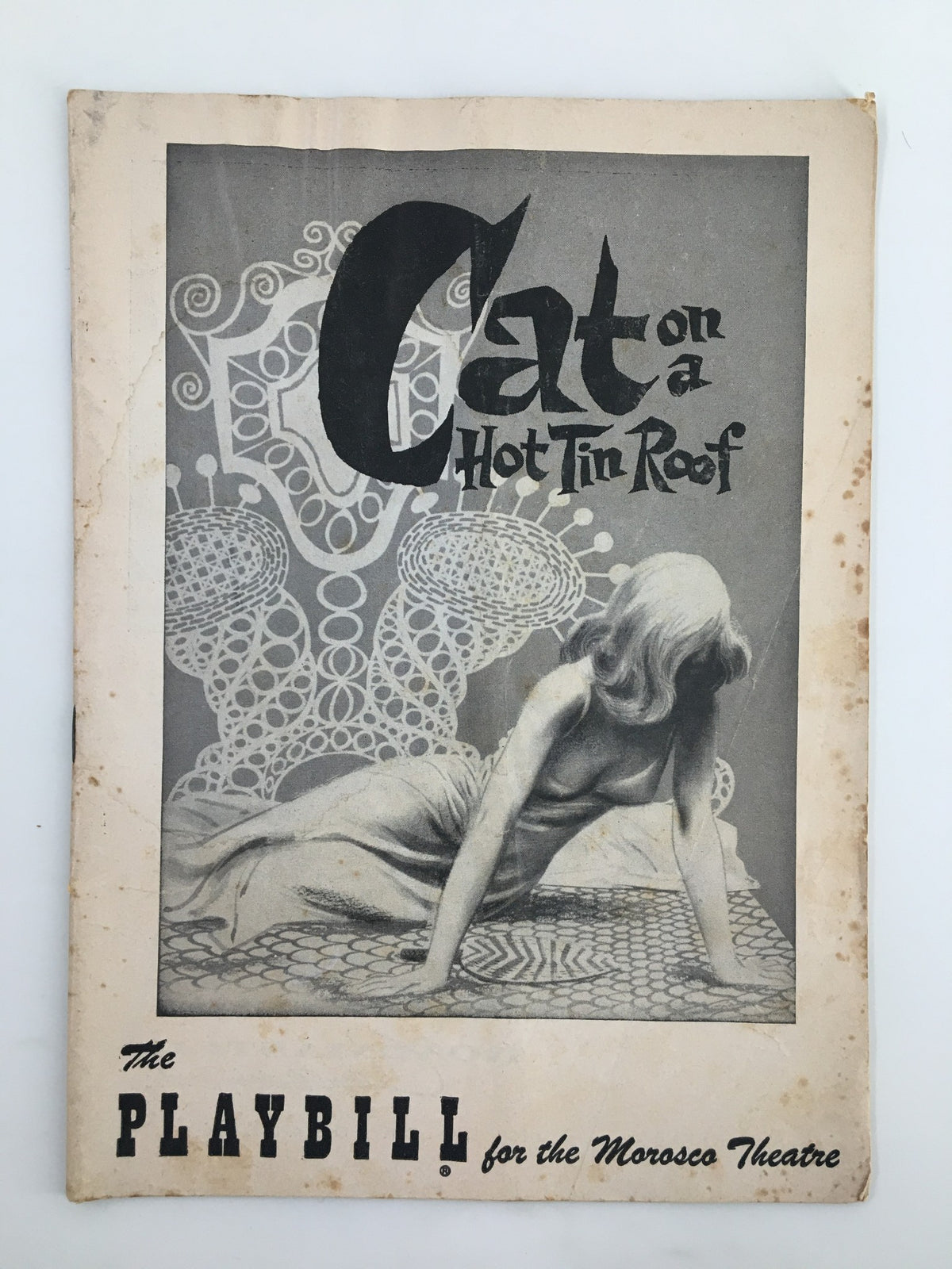 1955 Playbill for Morosto Theatre featuring 'Cat On A Hot Tin Roof', showcasing a vintage illustration with a woman in dramatic pose, representing the classic Tennessee Williams play.