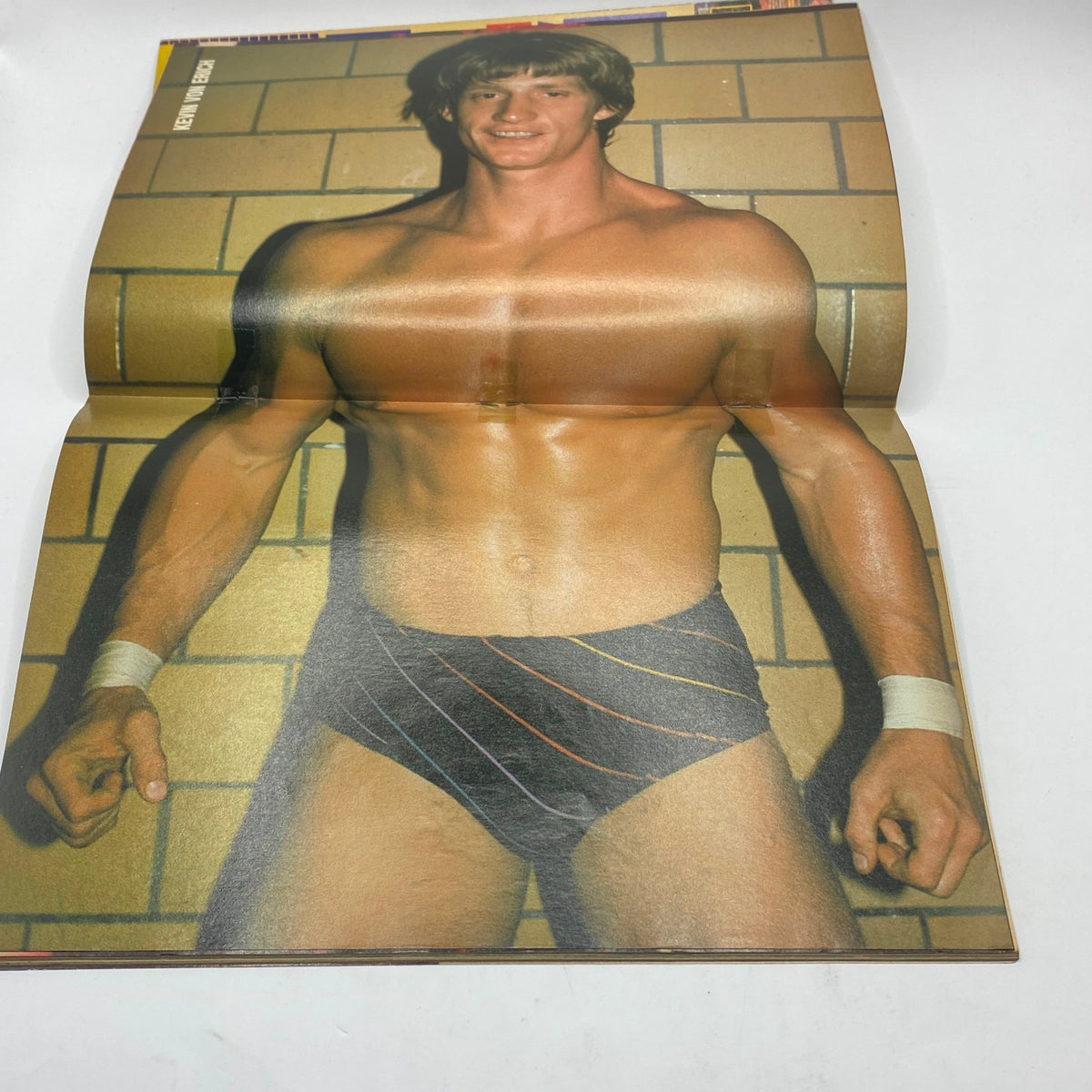 A highlighted image from Wrestling Scene Magazine February 1986 showcasing an athletic wrestler, possibly Kevin Von Erich, emphasizing the vibrant personalities of 1980s wrestling.