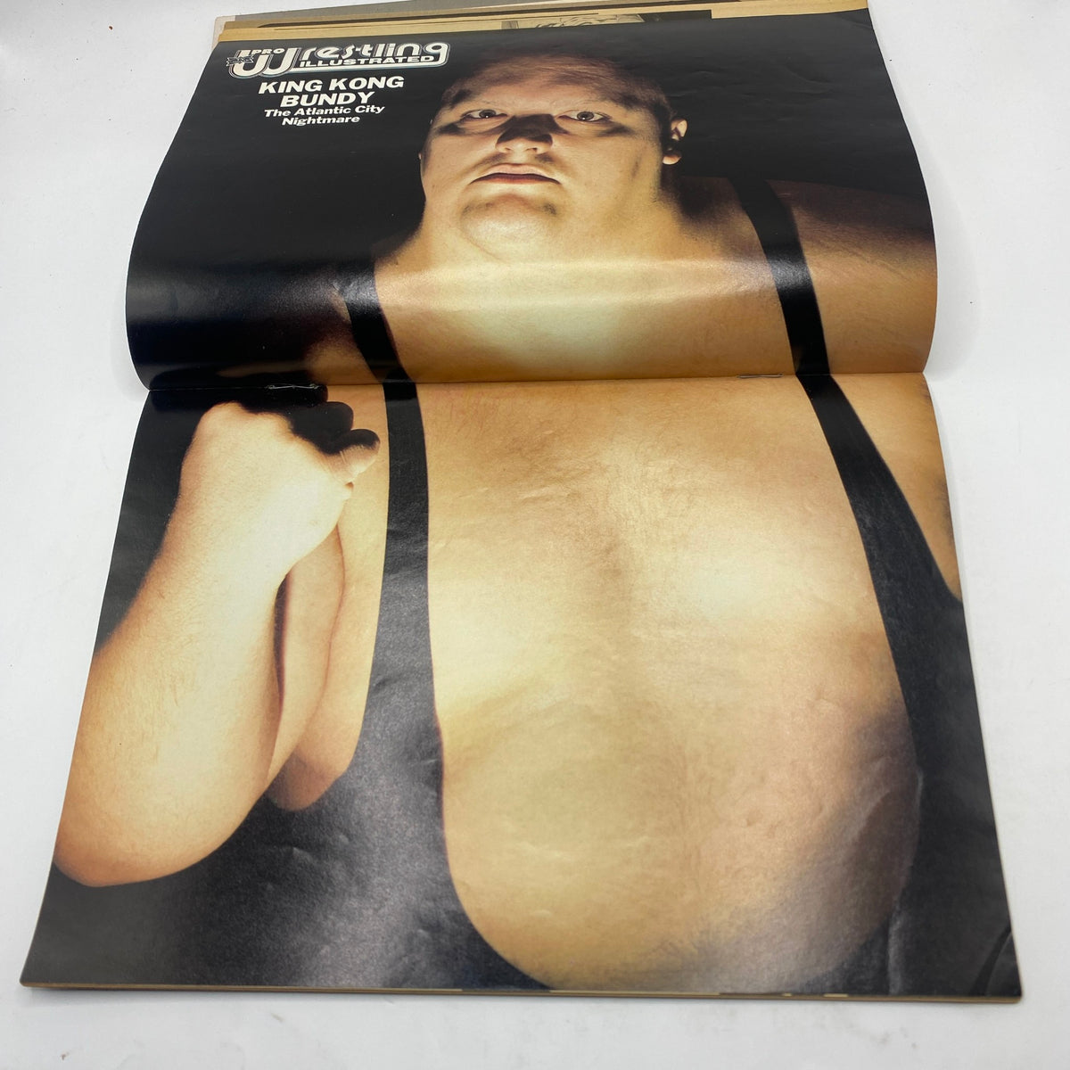 Pro Wrestling Illustrated Magazine July 1986 featuring King Kong Bundy on the cover, showcasing the iconic wrestler in a striking pose with a black background. Ideal for wrestling collectors.