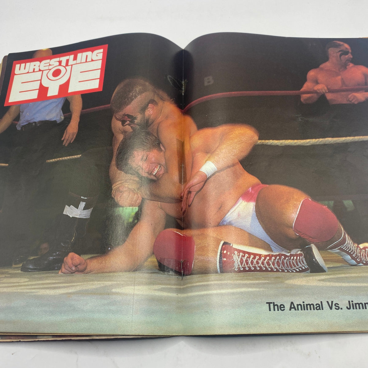 Inside view of Wrestling Eye Magazine November 1985 showcasing a wrestling match scene titled 'The Animal Vs. Jimmy'.