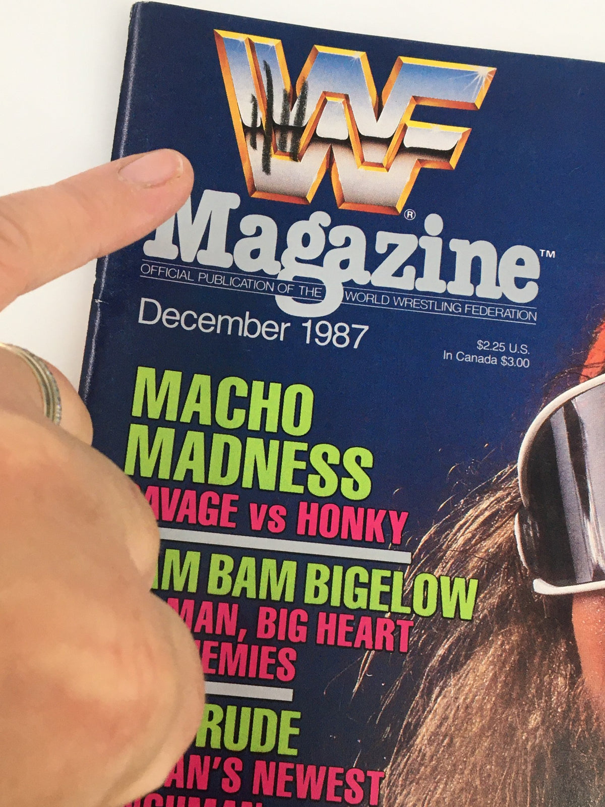 Close-up of the cover of VTG WWF Magazine December 1987 showing the title and a detailed look at text about Macho Madness featuring Randy Savage vs Honky Tonk Man.