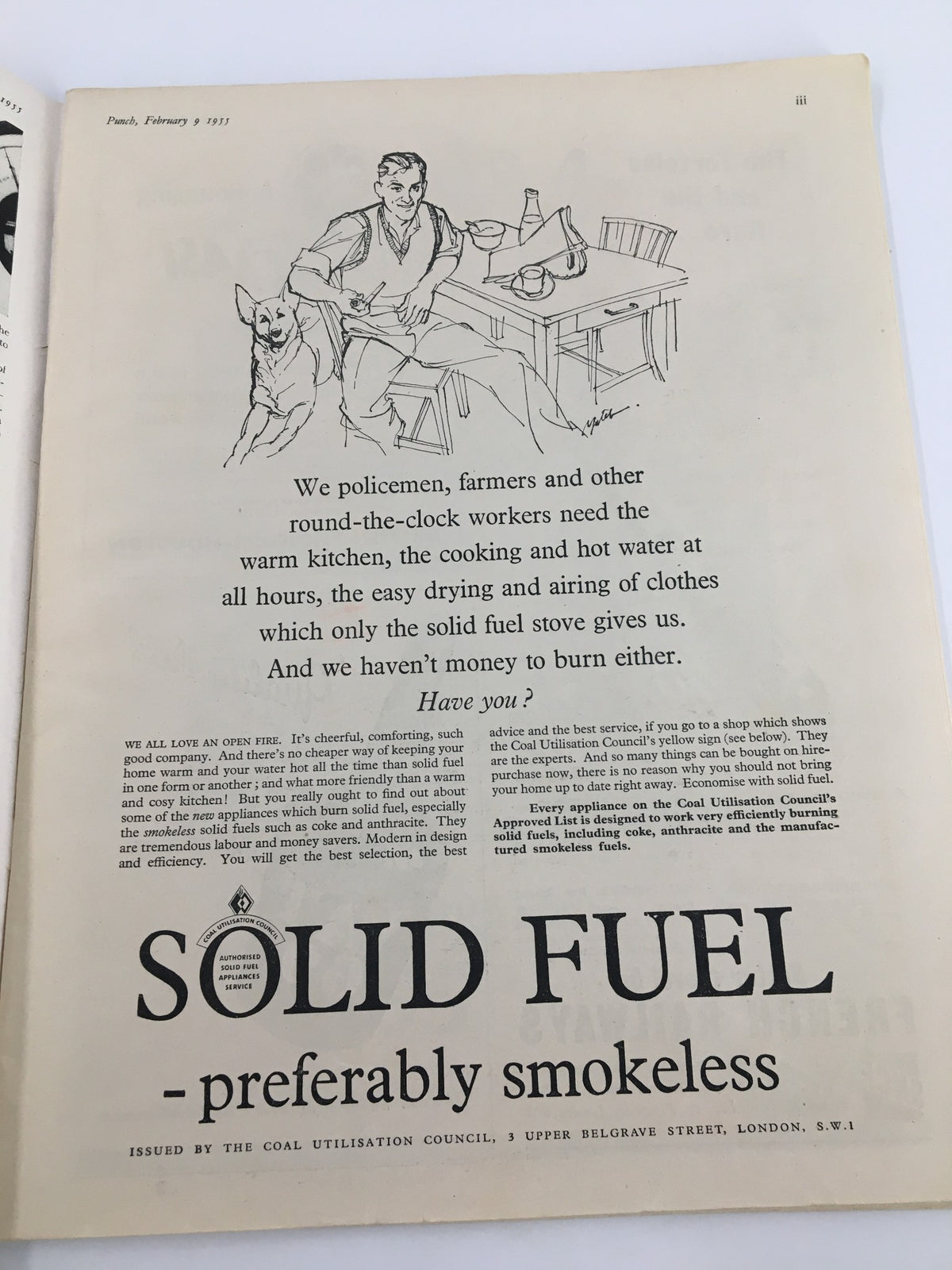 Illustration from VTG Punch February 9 1955 WWII Cartoon & Humour Magazine, depicting a seated man with a dog, discussing the benefits of solid fuel for heating.