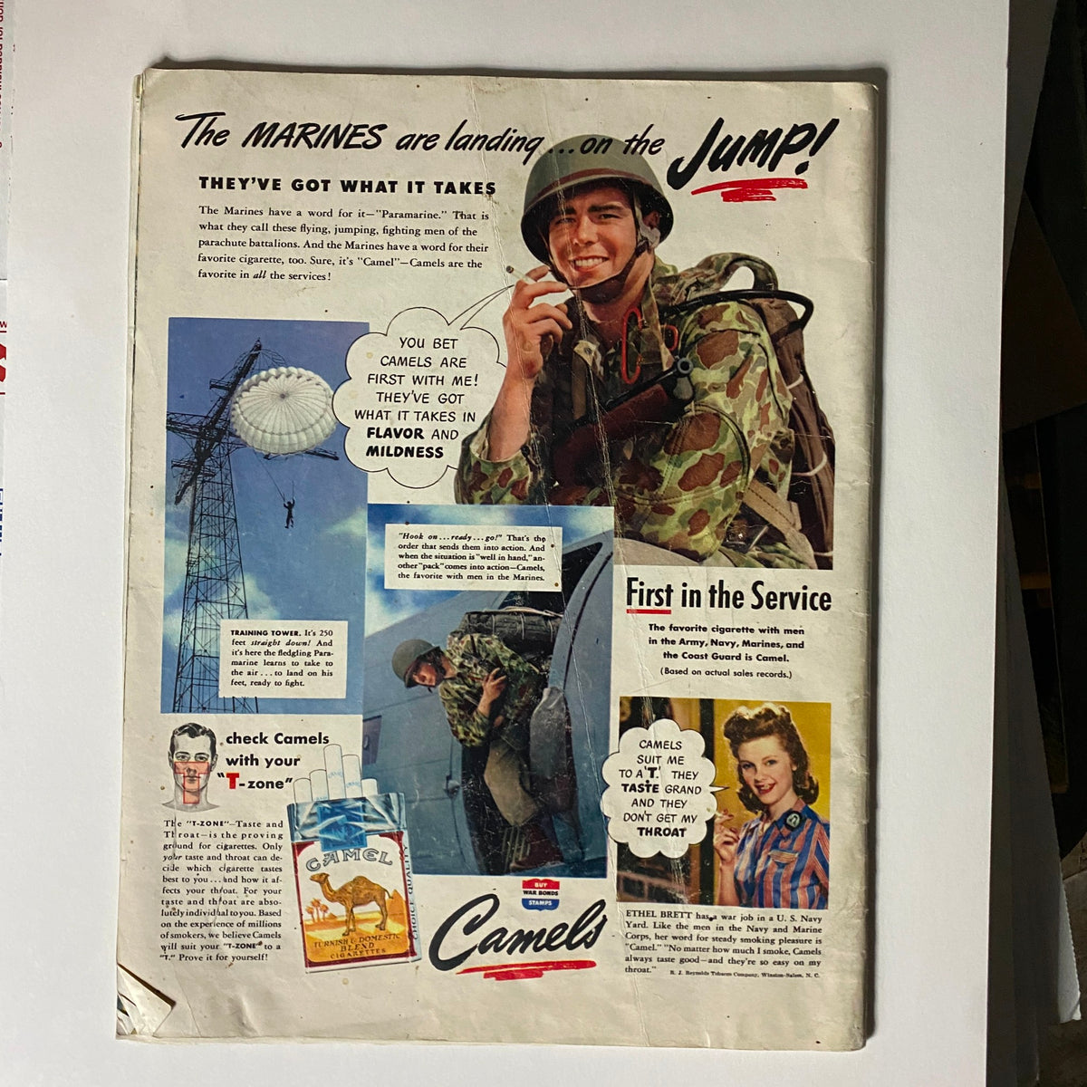 Vintage magazine advertisement for Camel cigarettes featuring a soldier, promoting the brand's flavors and mildness during World War II. The ad showcases a cheerful marine and highlights the phrase 'The MARINES are landing... on the JUMP!' from the Look Magazine January 25, 1944 with Anne Baxter and Farley Granger.