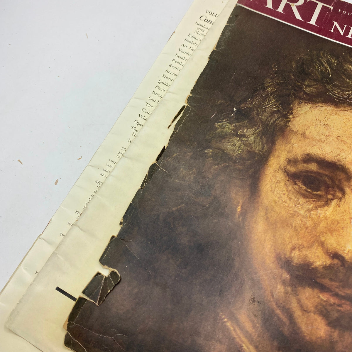 Damaged cover of 'Art News Magazine' from February 1, 1942, showing wear and tear, indicative of its vintage age and character.