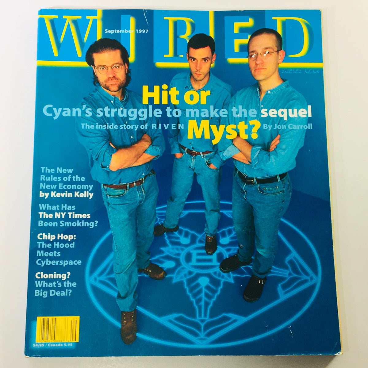 Wired Magazine September 1997 Vol 5 #9 cover featuring three men in blue shirts discussing Cyan's struggle to make the sequel to Myst, with highlighted text asking 'Hit or Myst?'.