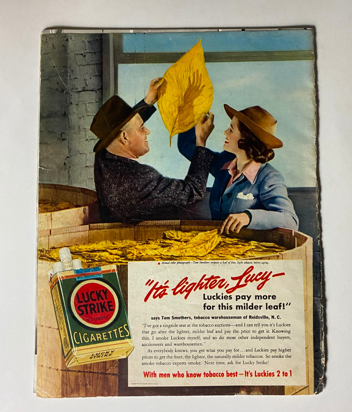 Vintage advertisement for Lucky Strike Cigarettes from the June 30, 1941 issue of Look Magazine, showcasing a tobacco auction scene with a farmer and a woman discussing tobacco leaves.