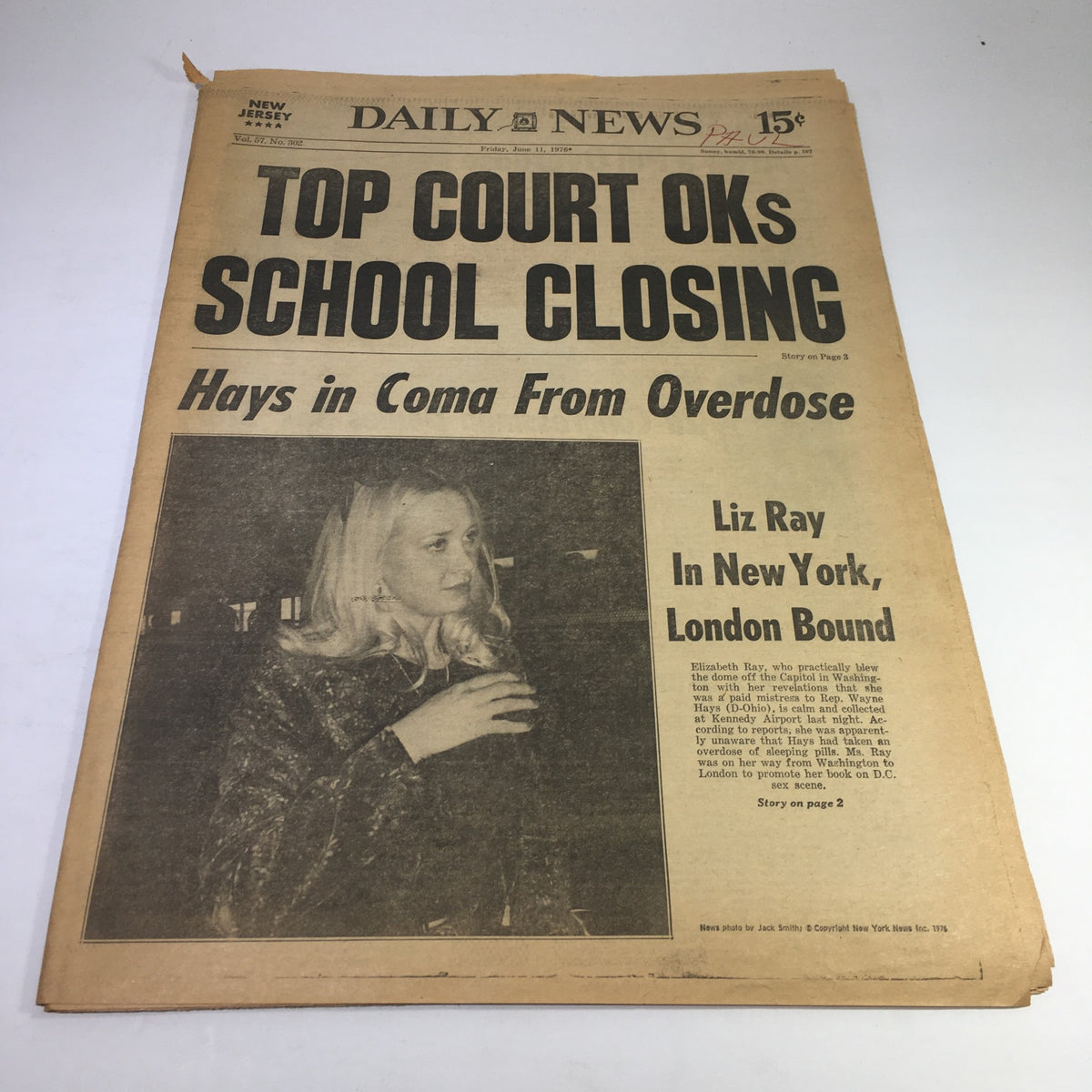 Vintage newspaper headline from the NY Daily News titled 'Top Court OKs School Closing: Hays in Coma From Overdose; Liz Ray In New York, London Bound'. This edition features a black and white image of Liz Ray, reported to be in New York.