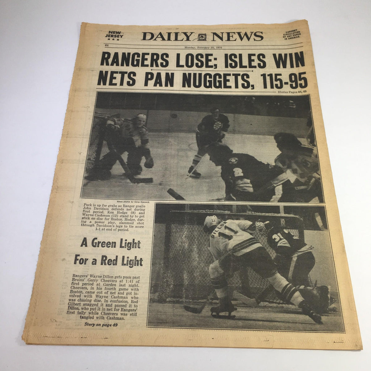 NY Daily News from February 23, 1976, featuring the headline 'Rangers Lose; Isles Win Nets Pan Nuggets, 115-95'. The newspaper showcases a significant moment in sports with a hockey game in action, reflecting the cultural and historical context of the 1970s.