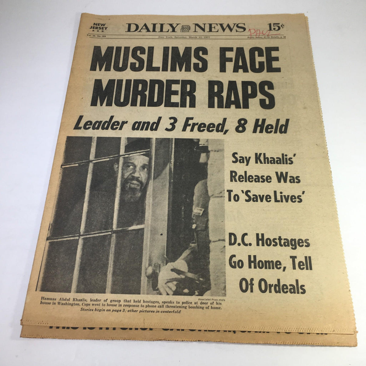 NY Daily News newspaper dated March 12, 1977, featuring the headline 'MUSLIMS FACE MURDER RAPS' covering the legal issues related to Hammas Abdul Khaalis, with a photo of Khaalis speaking through bars, highlighting historical and cultural significance.