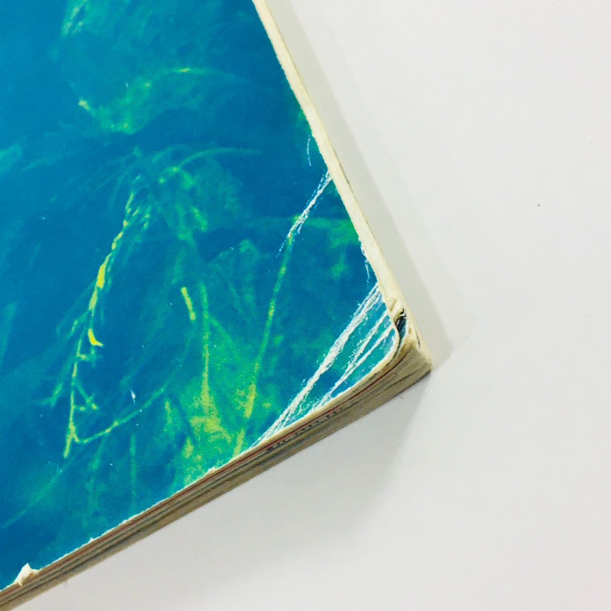 Close-up view of the spine and edge of Wired Magazine August 1994 Vol 2 #8, highlighting its vintage condition with slight wear and frayed edges.