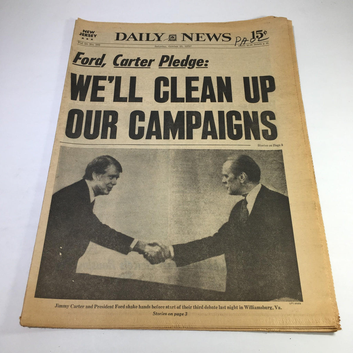 NY Daily News headline from 10/23/76 with President Ford and Jimmy Carter shaking hands, captioned 'We'll Clean Up Our Campaigns', depicting a pivotal moment from their political campaign.