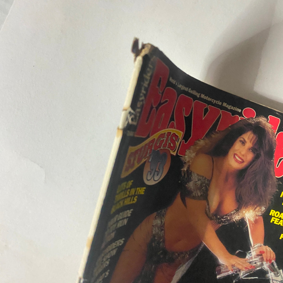Close-up view of the Easyriders Magazine December 1993 cover displaying the model and elements of the motorcycle, highlighting 90s biker culture with 'Sturgis 93' emphasized.