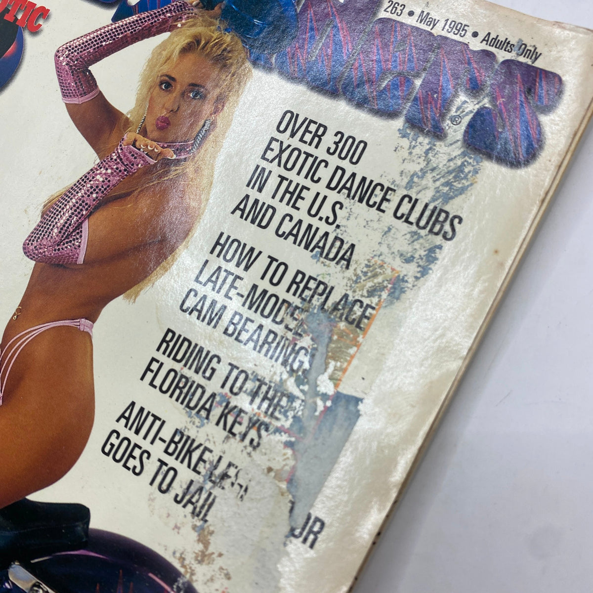 Close-up of the cover of Easyriders Magazine May 1995, showcasing details about motorcycle customization and a model in a pink outfit.