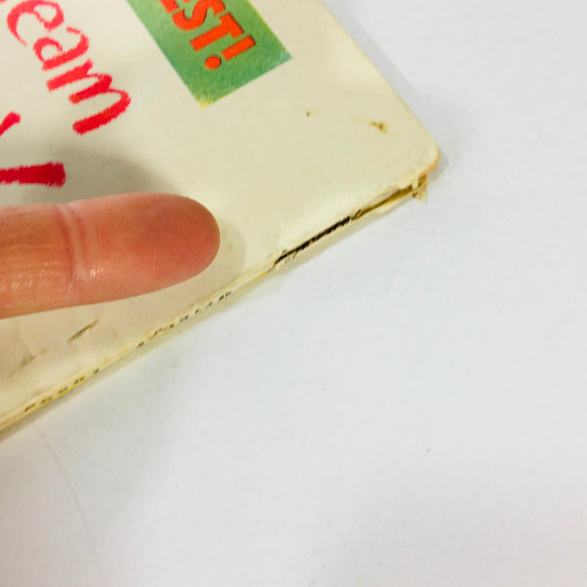 Close-up view of the edge of the VTG Radio-TV Mirror Magazine October 1953 showing minor wear and a finger indicating the condition of the magazine.