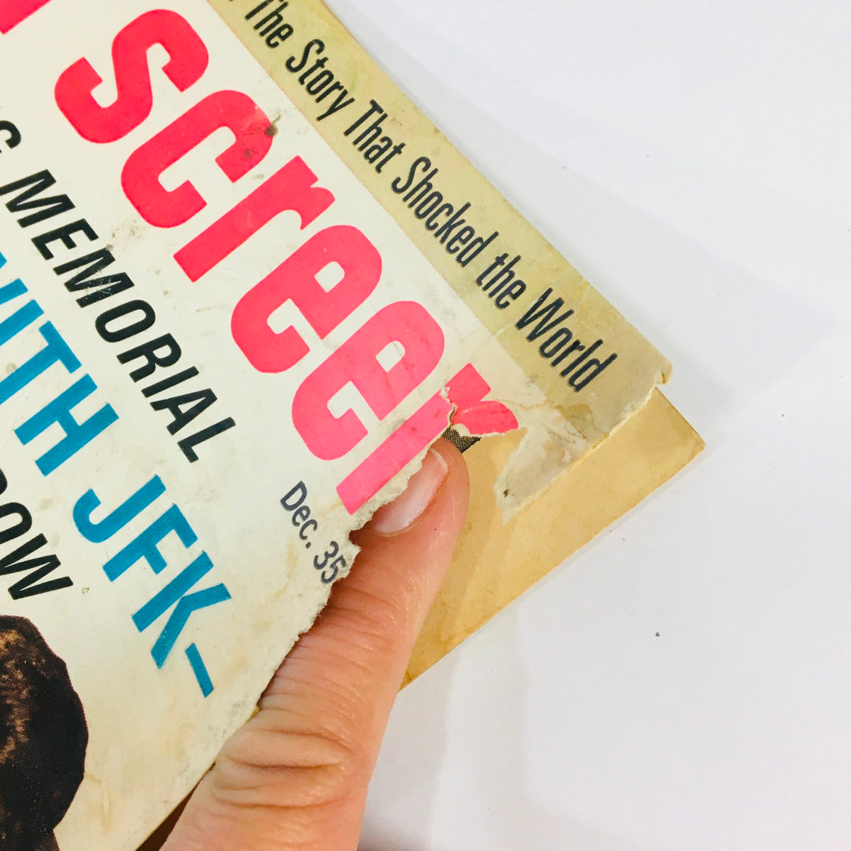 Close-up of the damaged cover of the December 1964 Modern Screen Magazine, showcasing the vintage charm and wear, emphasizing its collectible nature related to Jackie Kennedy and John F. Kennedy.